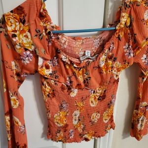Blouse coral color with flowers. Very cute never worn but without tags.